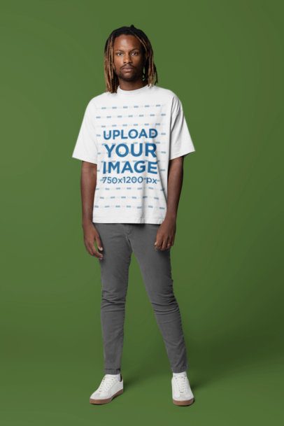 Mockup of a Man Standing in a Studio Wearing an Oversized T-Shirt 