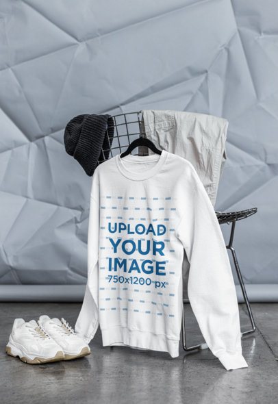 Mockup of a Gildan Sweatshirt Hanging on a Chair With a Streetwear Outfit m39778