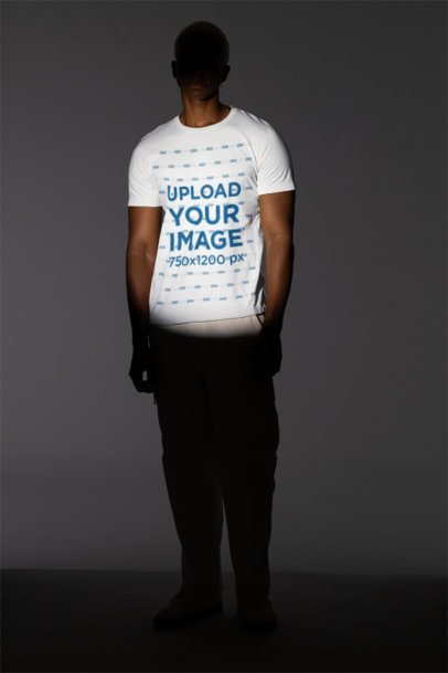 Bella Canvas T-Shirt Mockup Featuring a Man Posing Under a Spotlight in a Studio