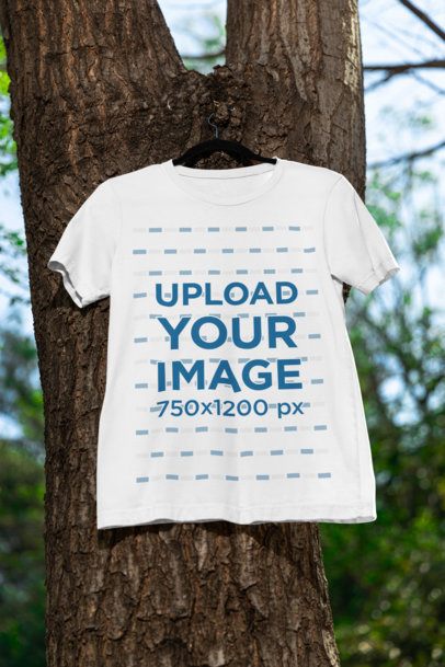 Mockup of a Bella Canvas Round-Neck Tee Hanging From a Tree m39830