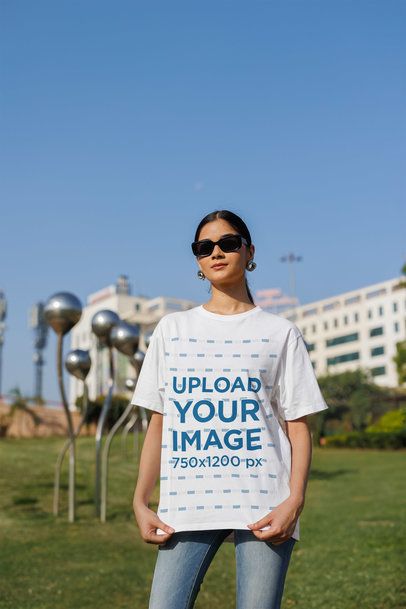 Oversized Blinkstore T-Shirt Mockup of a Gen Z Woman With Cool Sunglasses