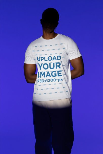 Bella Canvas Tee Mockup Featuring a Man with a Shadowed Face Standing in a Studio