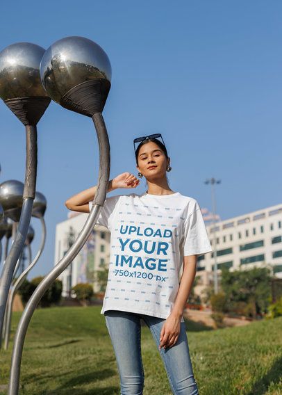 Blinkstore T-Shirt Mockup Featuring a Woman Posing in the Street With a Casual Look
