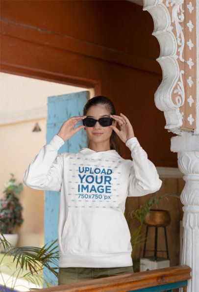 Mockup Featuring a Woman Wearing a Gildan Pullover Hoodie and Dark Sunglasses m40972