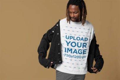 Mockup of a Man Wearing an Oversized Tee Under a Denim Jacket in a Studio