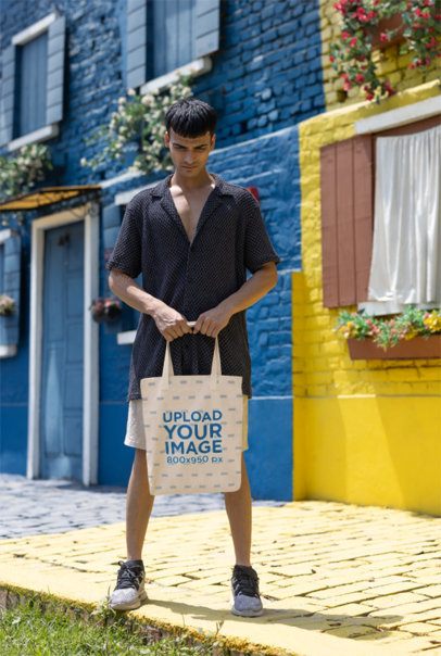 Mockup Featuring a Gen-Z Man Carrying a Tote Bag on the Street