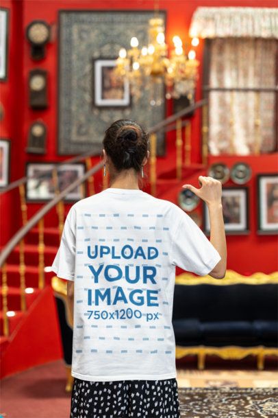 Mockup of the Back-View of a Woman Pointing at Her Blinkstore T-Shirt
