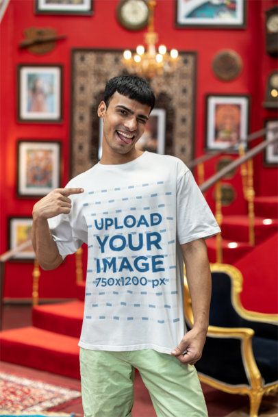 Mockup of a Gen-Zer Man Pointing at His Blinkstore T-Shirt and Winking an Eye m40996