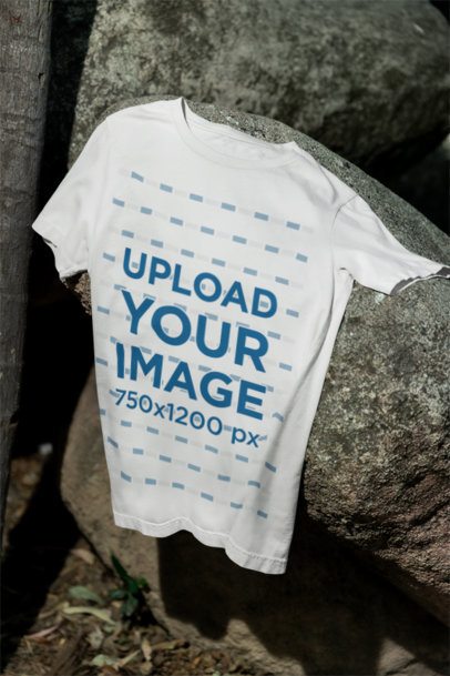 Mockup Featuring a Bella Canvas Round-Neck Tee Flat Laid over a Rock m39836