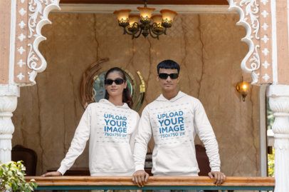 Mockup of a Man and a Woman Wearing Matching Sunglasses and Gildan Hoodies m40970