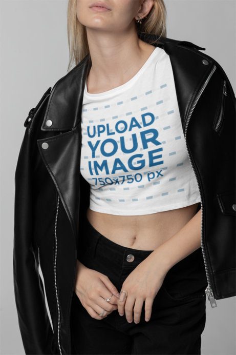 Closeup Mockup of a Woman Wearing a Bella Canvas Crop Top Under a Leather Garment