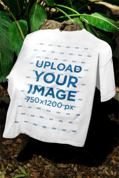 Mockup of a Round-Neck T-Shirt Lying Over a Rock and Some Plants m39842