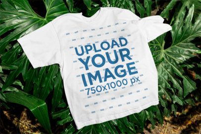 Mockup of a Crewneck T-Shirt Flat Laid over Tropical Leaves m39841