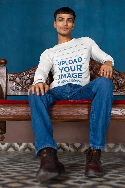 Bella Canvas Long Sleeve Tee Mockup of a Gen-Z Man Sitting on a Wooden Bench