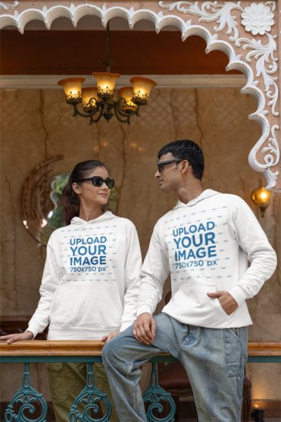 Gildan Pullover Hoodie Mockup Featuring a Gen Z Man and Woman Posing in a Balcony m40971
