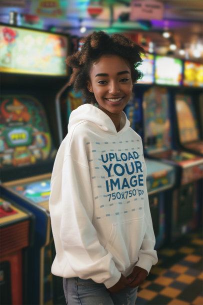 AI-Generated Mockup of a Smiling Woman with Curly Hair Wearing a Hoodie in an Arcade