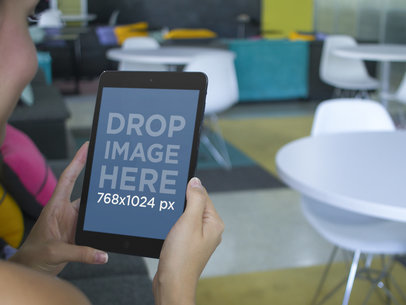 Young Lady Using a Black iPad at a Creative Office