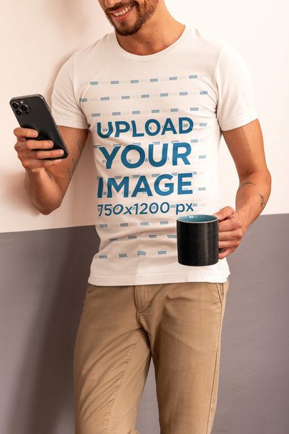 Bella Canvas Tee Mockup of a Smiling Cropped-Face Man Checking His Phone