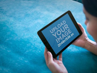 Tablet Mockup of Young Lady Using Her iPad Mini at Home