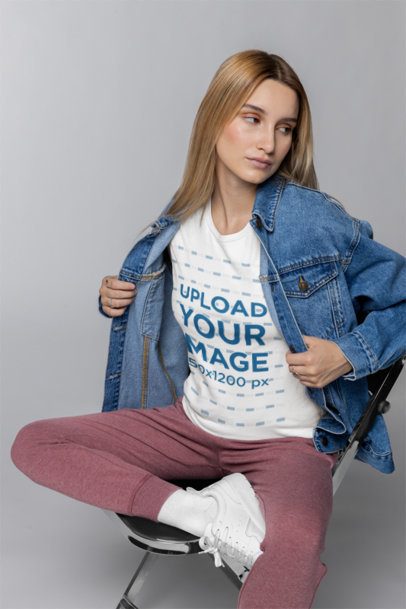 Bella Canvas T-Shirt Mockup of a Woman Sitting on a Chair in a Studio
