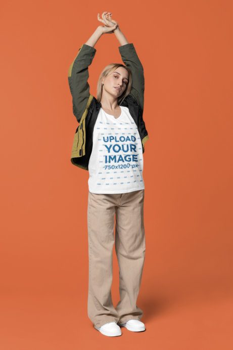 Mockup of a Woman in a Bella Canvas Tank Top Raising Her Hands over Her Head