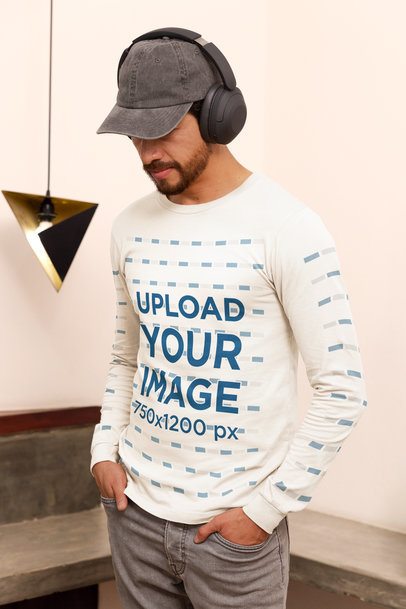 Bella Canvas Long-Sleeve Tee Mockup Featuring a Man With Headphones in a Homemade Feel Setting