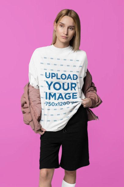 Mockup of a Woman in a Studio Wearing an Oversized T-Shirt with a Crew Neck