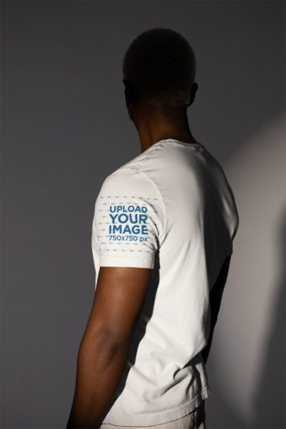 Mockup of a Man Wearing a Bella Canvas Tee with a Customizable Sleeve in a Studio