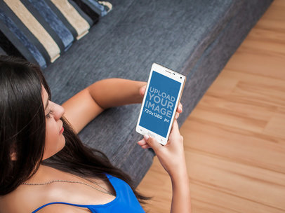 Mockup of a Young Woman Using Android Phone While Relaxing at Home