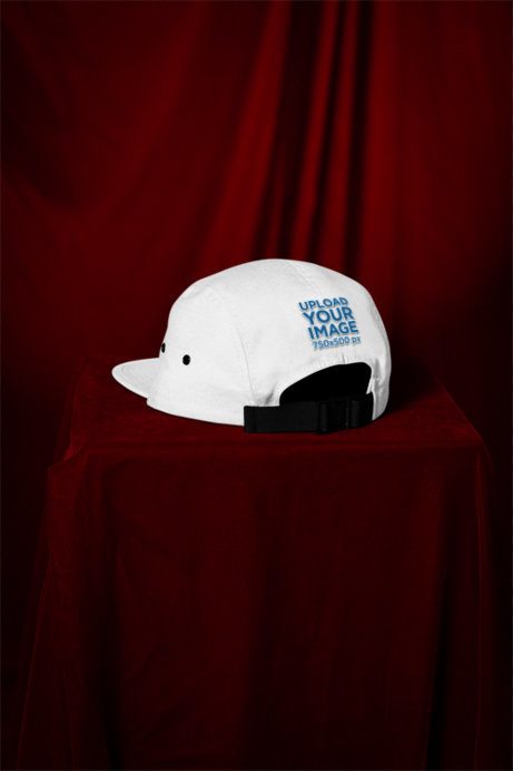 Mockup of a Yupoong Panel Cap Placed on a Red Sheet