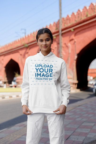 Gen Z Mockup Featuring a Happy Woman Wearing a Gildan Hoodie by the Street