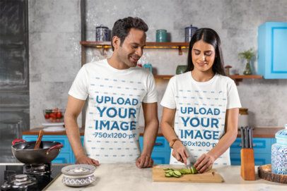Scott International T-Shirt Mockup Featuring a Happy Woman Chopping a Cucumber With Her Partner