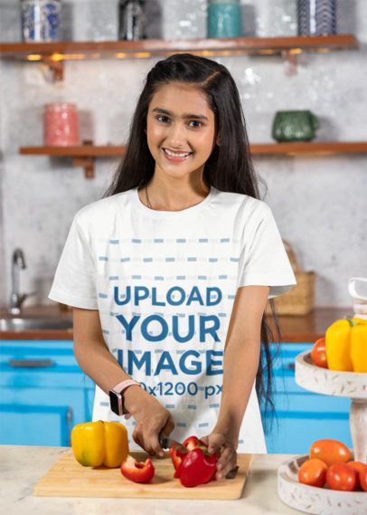 Scott International T-Shirt Mockup Featuring a Happy Teenage Girl Chopping Off Peppers