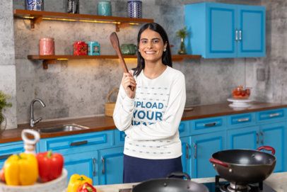 Bella Canvas Long-Sleeve Tee Mockup Featuring a Cheerful Woman With a Cooking Wooden Spoon