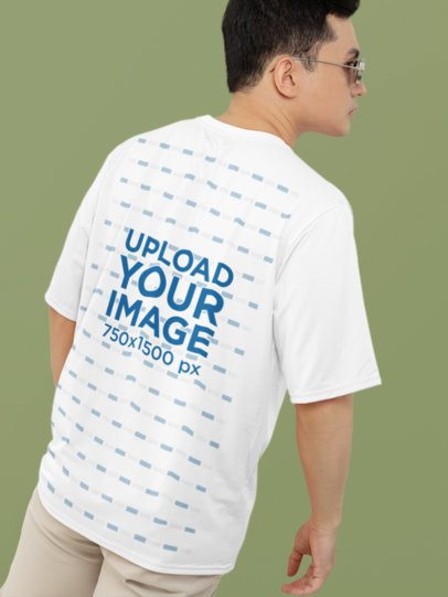 Back-View T-Shirt Mockup of a Man with Glasses Standing Against a Solid Background
