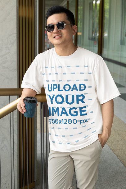 Rounded-Neck T-Shirt Mockup of a Man Holding a Drink in His Hand