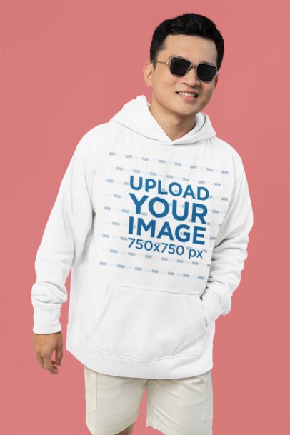 Mockup of a Smiling Man with Sunglasses Wearing a Hoodie in a Studio