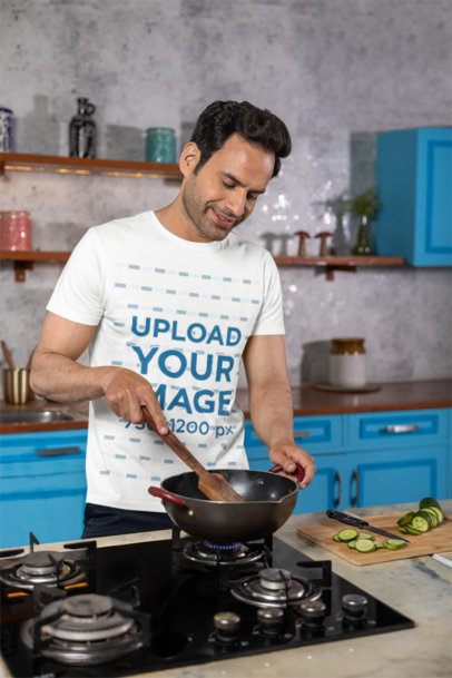 Scott International T-Shirt Mockup of a Happy Man Cooking in a Kitchen
