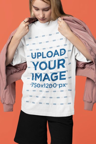 Oversized Tee Mockup of a Woman Putting on a Jacket in a Studio