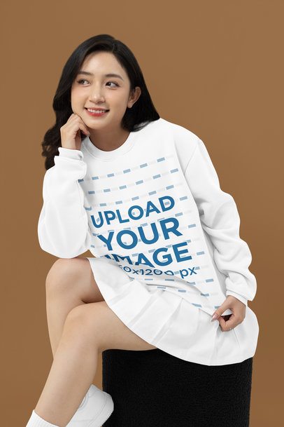 Mockup Featuring a Smiling Woman Wearing a Crewneck Sweatshirt inside a Studio