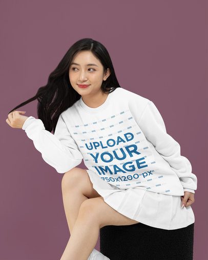Mockup of a Woman with a Smile on Her Face Wearing a Rounded-Neck Sweatshirt in a Studio