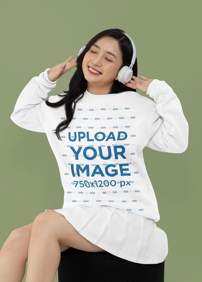 Crewneck Sweatshirt Mockup of a Smiling Woman Happily Listening to Music in a Studio