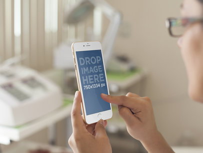 Mockup of a Spa Technician Using an iPhone 6 Plus at Work