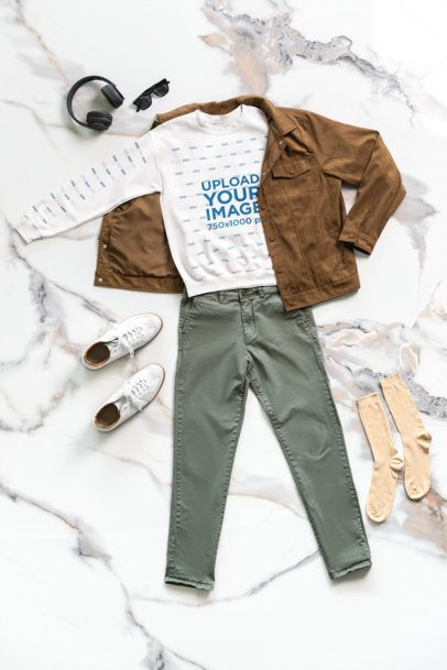 Mockup of a Cotton Heritage Sweatshirt Lying on the Floor With a Causal Outfit m50590