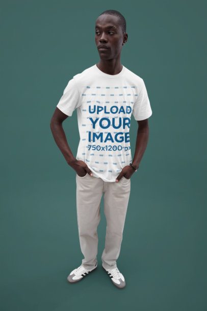 Mockup of a Man Standing in a Bella Canvas T-Shirt Against a Solid Backdrop