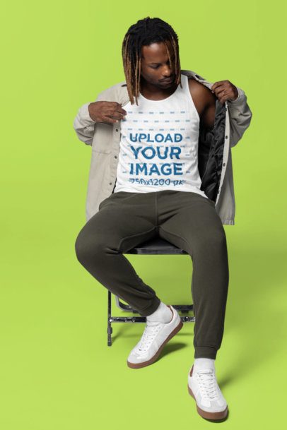 Bella Canvas Tank Top Mockup Featuring a Man With a Jacket Sitting on a Chair