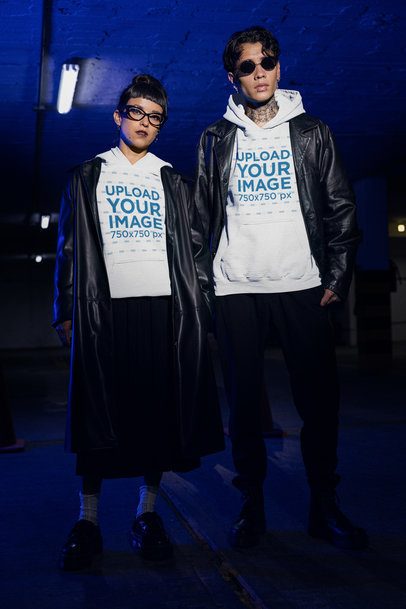 Gildan Hoodie Mockup Featuring a Woman and a Tattooed Man in Gothic Styles