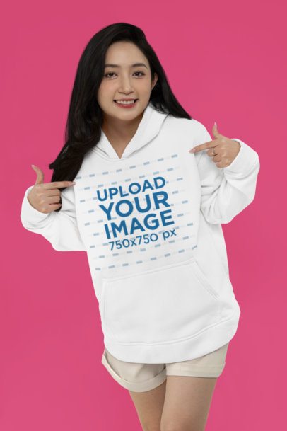 Mockup Featuring a Smiling Woman Pointing at Her Pullover Hoodie