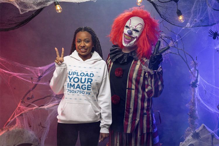 Gildan Hoodie Mockup of a Smiling Woman Posing With an Evil Clown
