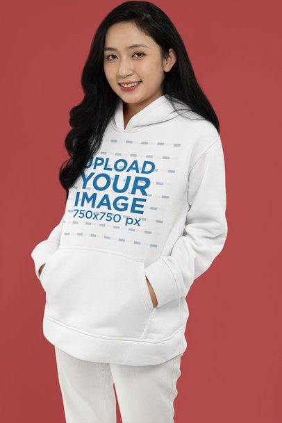 Mockup Featuring a Happy Woman Wearing a Pullover Hoodie in a Studio